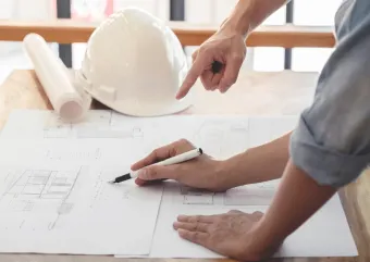 A engineering looking at building plans 