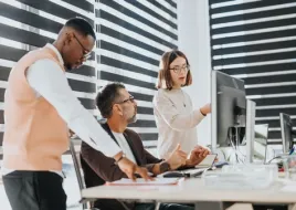 A team of architects looking at plans  